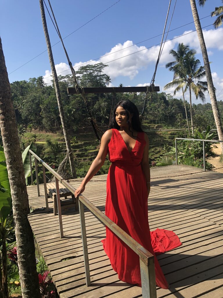 Woman in red dress at Bali swing in Indonesia